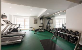 The room is spacious and contains multiple exercise equipment, as well as an indoor gym area at Paramount Gallery Hotel