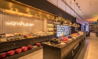 The restaurant features a wide variety of food displayed on the counter in front, complemented by an open concept at CitiGO Hotel Sanyuanqiao Beijing