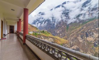 The balcony offers a scenic view of mountains and valleys in an alpine region at Tina's Youth Hostel