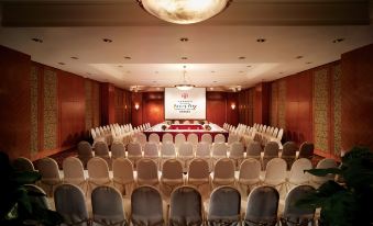 A spacious room is arranged with rows of chairs for an event at a hotel or conference at Harbour Plaza Resort City