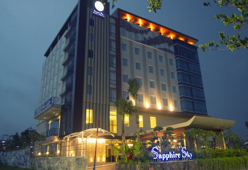 "a large hotel with a blue sign that says "" sapphire sky "" in front of it" at Sapphire Sky Hotel & Conference