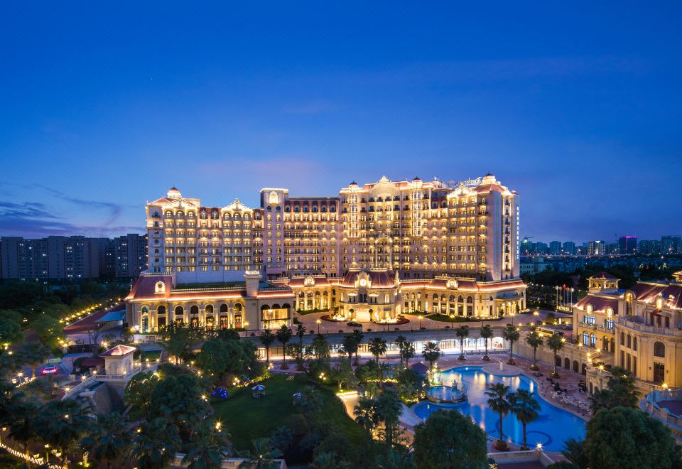 The hotel and resort are illuminated at night, with a city in the foreground at Radisson Blu Forest Manor Shanghai Hongqiao