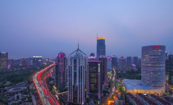 A city's illuminated skyline at night, with buildings on both sides at Golden Tulip Shanghai