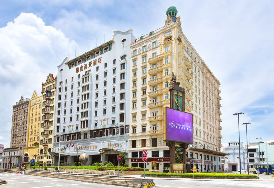 There is a large building with a visible exterior and a prominently displayed name in front at Harbourview Hotel