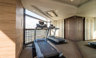 a modern gym with two treadmills , one on the left side and the other on the right side of the room at HOTEL MYSTAYS Utsunomiya