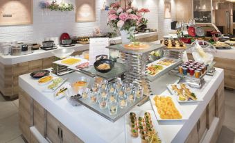 a buffet table filled with a variety of food items , including sandwiches , pastries , and desserts at HOTEL MYSTAYS Fuji Onsen Resort