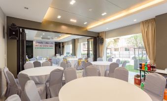 a large banquet hall with round tables covered in white tablecloths , creating a festive atmosphere at Grand Inter Hotel