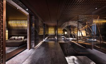 The room has two beds and an open doorway that leads to the restroom at Nuo Hotel Beijing
