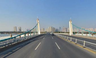 a bridge spanning a river , with cars driving on the bridge and tall buildings in the background at Rome Hotel