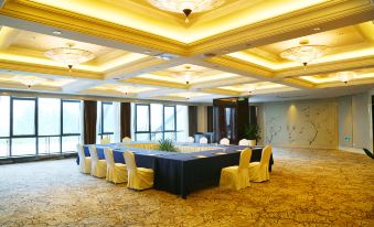 There is a spacious room arranged with long tables and chairs for hosting events or functions at KinDream Hotel