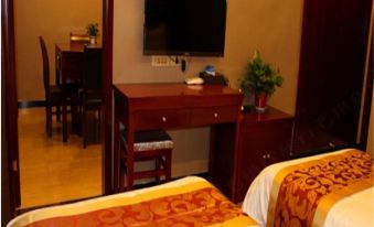 The room is equipped with a bed, desk, and television, and features large windows on both sides at Famen Temple Hotel