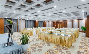 a large conference room with multiple tables and chairs arranged for a meeting or event at Paris Deli Danang Beach Hotel
