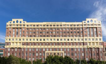 "a large , red - brick building with many windows and a sign that says "" coleridge "" is shown against a blue sky" at Oaks Sydney Goldsbrough Suites