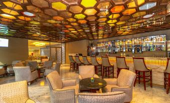 a well - lit restaurant with various dining tables and chairs , creating an inviting atmosphere for customers at Marino Beach Colombo