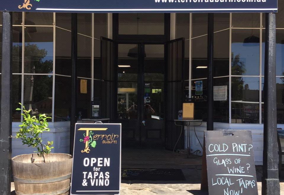 "a storefront with a sign that reads "" trepadora winery "" and a storefront window displaying the name of the winery" at Terroir Auburn