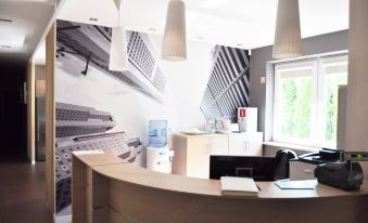 a reception area with a desk , chairs , and a large wall mural of city skyscrapers at Best East