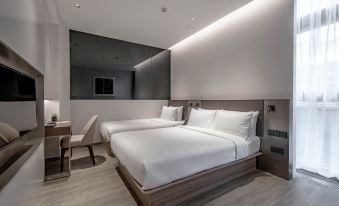 Our hotel suite includes a bedroom with two beds and an attached bathroom at Aerotel Beijing