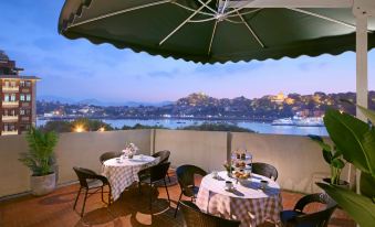 There is a table and chairs on the terrace that offer a view of the outdoors or another spacious area at Chunguang Hotel