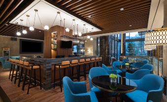 a restaurant with tables and chairs in the center, as well as other seating areas for customers at Ramada Shanghai Pudong International Airport East Station