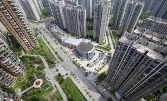 aerial view of a city with tall buildings and a parking lot in the foreground at Mediterranean Hotel
