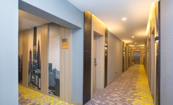 a long hallway with carpeted floors, featuring doors and an adjacent office at Jimu Xiaozhu Hotel (Shanghai Jing'an Temple)