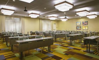 a large conference room with multiple rows of tables and chairs arranged for a meeting or event at Fairfield Inn & Suites by Marriott Tustin Orange County