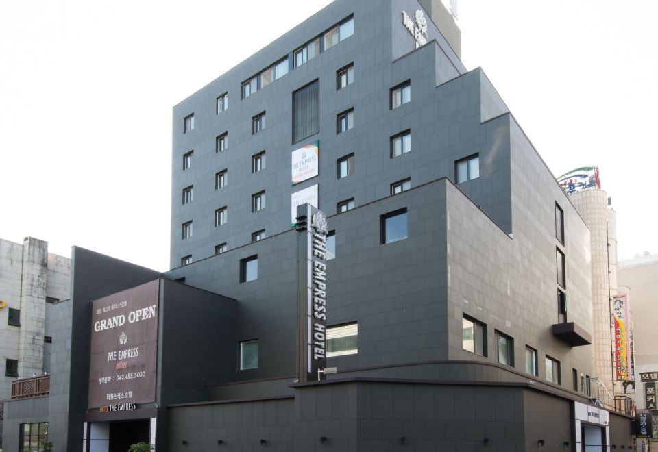 "a modern , gray building with multiple stories and a sign reading "" asakawa department store "" on the ground floor" at The Empress Hotel