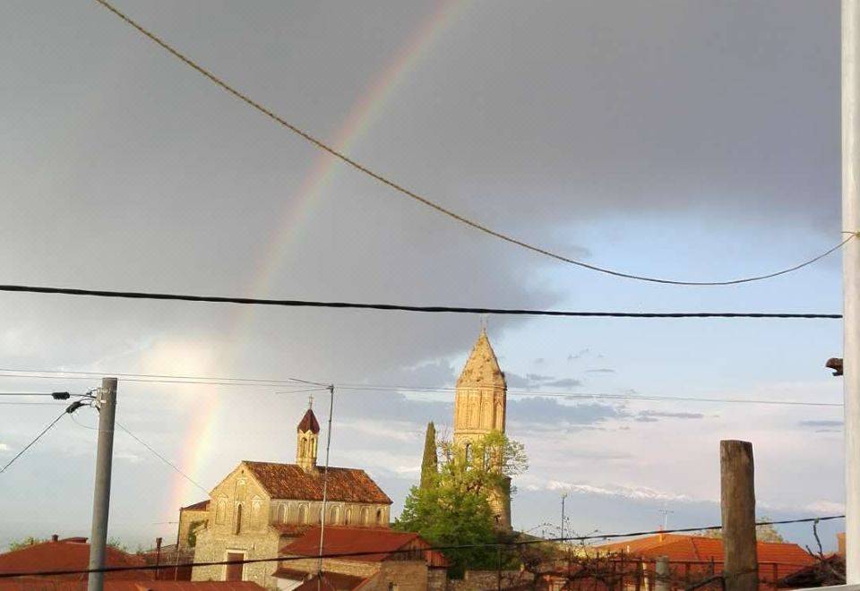 a view of a church and a city with a double rainbow in the sky at Veranda