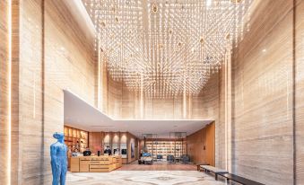 The lobby is designed to resemble a library, featuring bookshelves and an atrium at Atour Hotel (Shenzhen Nanshan Vanke Yuncheng)