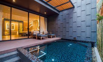 a modern outdoor living space with a pool , lounge chairs , and umbrellas under a wooden ceiling at The Yana Villas Hua Hin