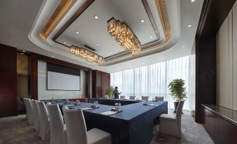 There is a spacious conference room equipped with long tables and chairs suitable for meetings and other business events at Shangri-La Yiwu