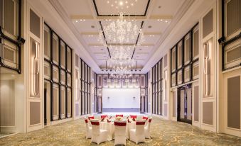 A spacious room is arranged with tables and chairs for events or formal dining at International Youth Convention Hotel (Nanjing International Youth Cultural Centre)