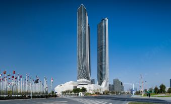 There is a large building with multiple towers in the middle and a tall skyscraper behind it at International Youth Convention Hotel (Nanjing International Youth Cultural Centre)