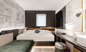 A modern bedroom on an island near with a large bed and a small desk in the middle at CitiGO Hotel Sanyuanqiao Beijing