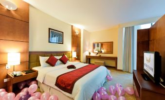 a hotel room with a large bed covered in pink and white balloons , creating a festive atmosphere at Muong Thanh Dien Chau Hotel