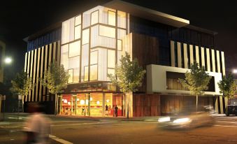 a large building with a restaurant on the ground floor and people dining in the kitchen at The Urban Newtown