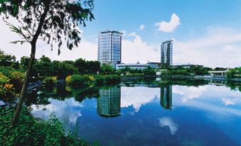 There is a large body of water with buildings in the background, which includes an artificial lake or pond at Harbour Plaza Resort City