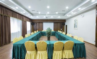 a large conference room with a long table and chairs arranged in a semicircle around it at Panda Hotel