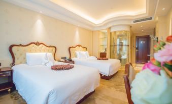 The spacious bedroom features two double beds and a connected sitting area for two at Longyou International Grand Hotel