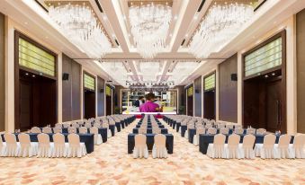 a large conference room with rows of tables and chairs set up for a meeting at Kusatsu Hotel