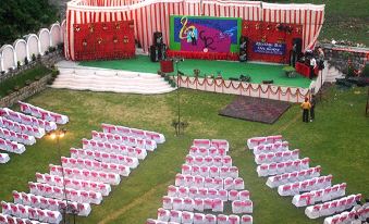 an aerial view of a large outdoor event with multiple tents and chairs set up for an event at Hotel Grand Riviera