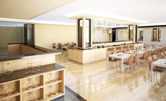 a modern , well - lit restaurant with wooden flooring and a long bar counter , containing various dining tables and chairs at Savero Hotel Depok