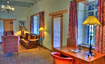 a living room with a couch , a desk , and a door leading to a bedroom at Tubac Golf Resort & Spa