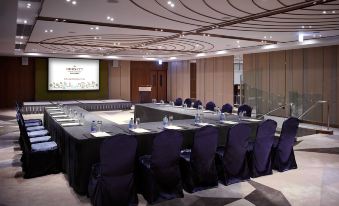 a conference room set up for a meeting , with chairs arranged in a semicircle and a podium at the front at Dorsett Wanchai