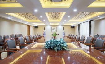a large conference room with a long wooden table and numerous chairs arranged around it at Madison Hotel