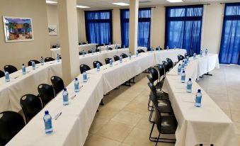 a large conference room with long tables and chairs arranged for a meeting or event at Cape Eleuthera Resort & Marina