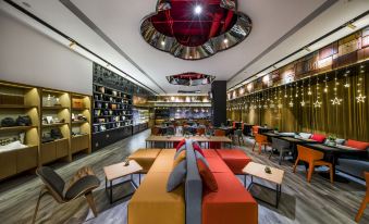 The restaurant features an interior design that includes tables, chairs, and a bar located at the front on one side at CitiGO Hotel Beijing Tian'anmen Square
