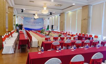 a large conference room with multiple tables and chairs set up for a meeting or event at Seagull Hotel