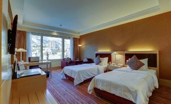 The bedroom features large windows and two queen-sized beds, located in the same area as other amenities at Parsian Azadi Hotel