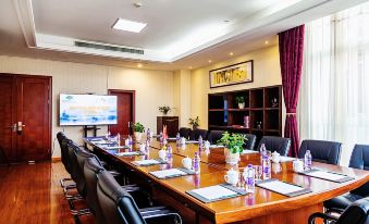 There is a spacious conference room equipped with long tables and chairs suitable for meetings and other business events at Huachen San Siro Hotel